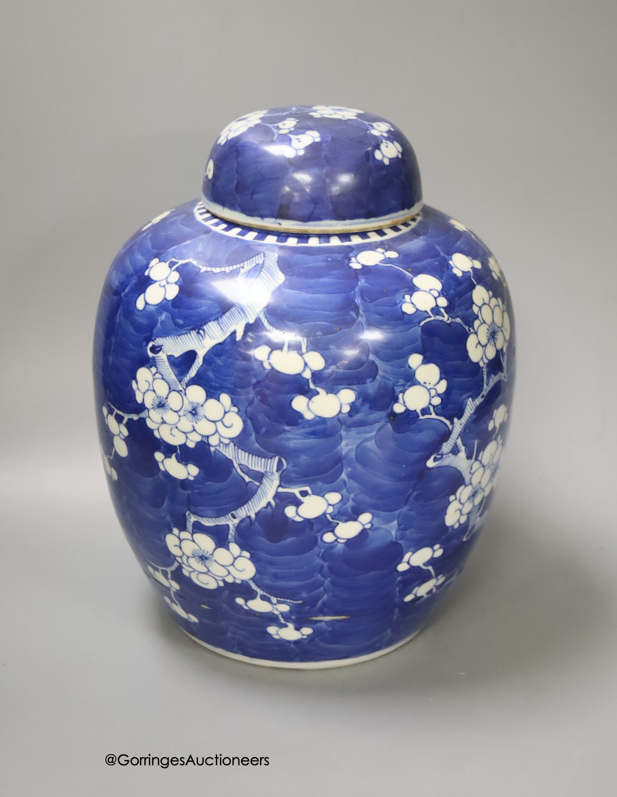 A 19th century Chinese porcelain prunus jar and cover, 27cm, on carved wood stand, a smaller famille noire jar and cover, a Chinese export fruit bowl, blue and white dish and a similar jar and cover 27cm